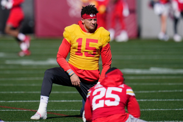 kansas-city-chiefs-quarterback-patrick-mahomes-15-stretches-with-teammates-including-running-back-clyde-edwards-helaire-25-during-an-nfl-football-practice-in-tempe-ariz-wednesday-feb-8-202