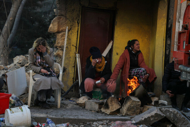 people-sit-by-the-debris-of-their-collapsed-house-in-hatay-southern-turkey-thursday-feb-9-2023-emergency-crews-made-a-series-of-dramatic-rescues-in-turkey-on-friday-pulling-several-people-some