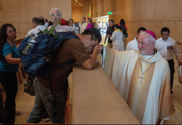 auxiliary-bishop-david-oconnell-right-from-the-san-gabriel-pastoral-region-is-revered-by-an-unidentified-pilgrim-left-after-a-special-mass-in-recognition-of-all-immigrants-at-the-los-angeles