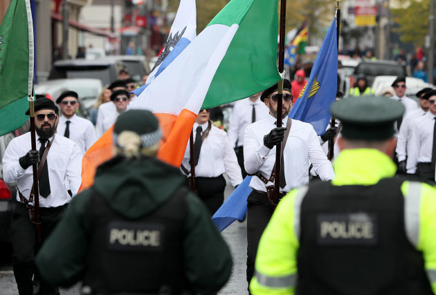 psni-officers-watch-as-a-colour-party-takes-part-in-a-parade-in-newry-co-down-the-political-party-saoradh-had-organised-the-parade-to-commemorate-hunger-strikes