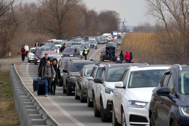 ukrainian-refugees-walk-along-vehicles-lining-up-to-cross-the-border-from-ukraine-into-moldova-at-mayaky-udobne-crossing-border-point-near-udobne-ukraine-saturday-feb-26-2022-the-u-n-refugee-a