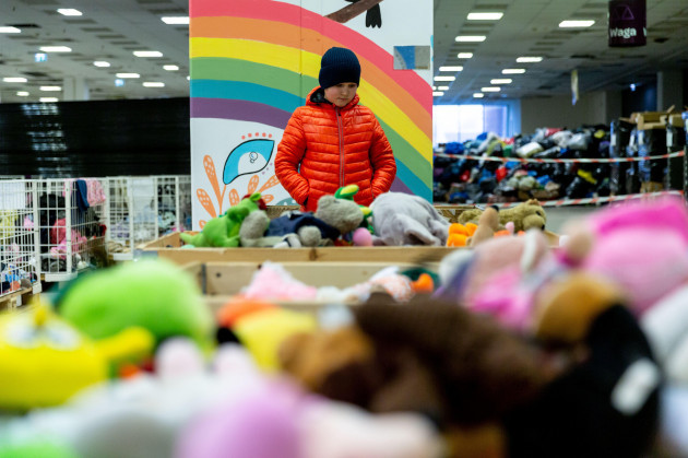a-ukrainian-refugee-boy-searches-for-toys-in-plaza-centre-in-krakow-poland-where-internationaler-bund-polska-foundation-provides-free-goods-for-war-escapees-as-more-than-two-million-people-have-alrea