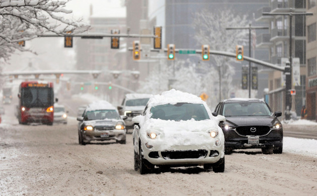 vehicles-travel-on-a-snow-covered-state-street-during-a-snowstorm-in-salt-lake-city-utah-on-wednesday-feb-22-2023-a-brutal-winter-storm-knocked-out-power-in-california-closed-interstate-highway
