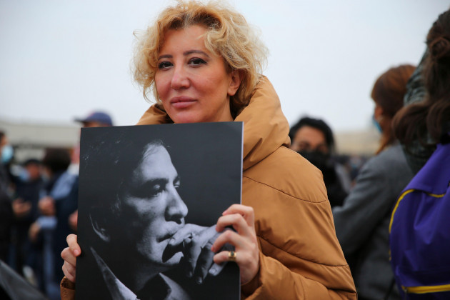 a-protester-holds-a-photo-of-former-president-mikheil-saakashvili-during-a-rally-in-front-of-the-prison-where-the-former-president-is-being-held-in-rustavi-about-20-km-from-the-capital-tbilisi-geor