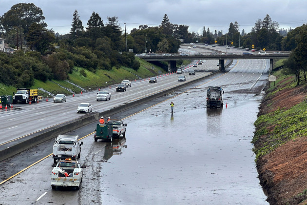 caltrans-crews-work-by-a-flooded-section-of-interstate-580-in-oakland-calif-friday-march-10-2023-a-new-atmospheric-river-has-brought-heavy-rain-and-thunderstorms-to-california-bringing-flood-th