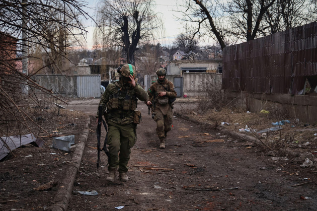 ukrainian-soldiers-walk-along-a-street-in-the-area-of-the-heaviest-battles-with-the-russian-invaders-in-bakhmut-donetsk-region-ukraine-wednesday-march-15-2023-ap-photoroman-chop