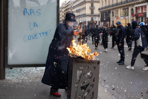 march-23-2023-paris-france-an-elderly-lady-starts-a-trash-fire-clashes-on-the-sideline-of-a-protest-a-few-days-after-the-government-pushed-their-pension-reform-through-parliament-without-a-vote