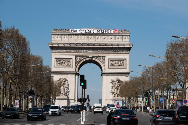 paris-france-05th-apr-2023-a-banner-reading-64-it-is-no-hangs-on-the-top-of-the-triumph-arc-during-an-action-by-demonstrators-against-the-governments-pension-reform-in-paris-france-on-april