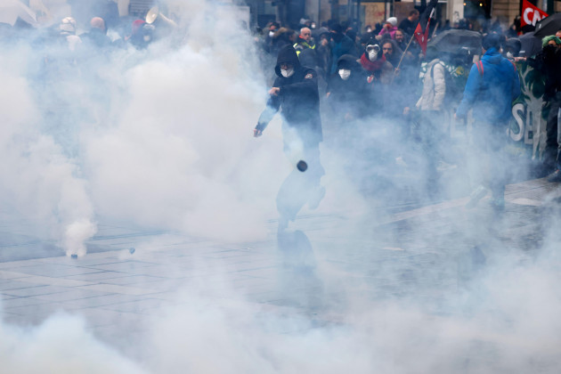 a-youth-kicks-a-tear-gas-canister-during-a-protest-thursday-april-6-2023-in-nantes-western-france-hundreds-of-thousands-of-people-are-expected-to-fill-the-streets-of-france-thursday-for-the-11th-d