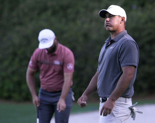 augusta-united-states-09th-apr-2023-brooks-koepka-l-reacts-after-missed-putt-on-the-13th-standing-next-to-leader-jon-rahm-during-the-final-round-at-the-87th-masters-tournament-at-augusta-nationa