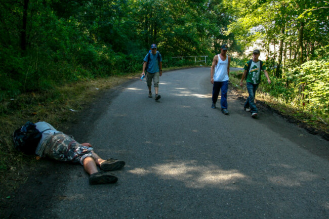 drunk-man-asleep-czech-techno-music-festival-czech-republic-rural-road