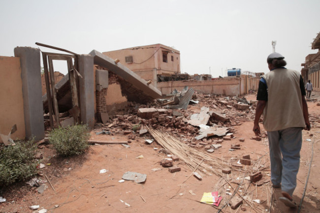 a-man-walks-by-a-house-hit-in-recent-fighting-in-khartoum-sudan-tuesday-april-25-2023-sudans-warring-generals-have-pledged-to-observe-a-new-three-day-truce-that-was-brokered-by-the-united-states