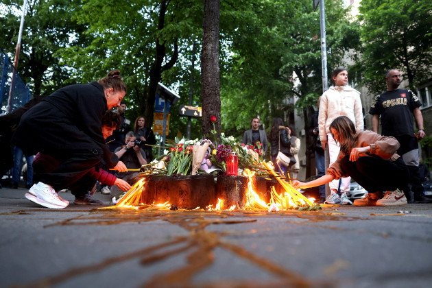 people-light-candles-near-the-vladislav-ribnikar-school-in-belgrade-serbia-wednesday-may-3-2023-a-13-year-old-who-opened-fire-wednesday-at-his-school-in-serbias-capital-drew-sketches-of-classroo