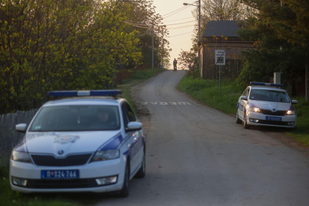 police-officers-guard-a-road-in-the-village-of-dubona-some-50-kilometers-30-miles-south-of-belgrade-serbia-friday-may-5-2023-as-they-block-the-road-near-the-scene-of-a-thursday-night-attack-a