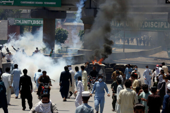 supporters-of-pakistans-former-prime-minister-imran-khan-walk-next-to-a-burning-car-during-a-protest-against-the-arrest-of-their-leader-in-peshawar-pakistan-wednesday-may-10-2023-pakistan-brace
