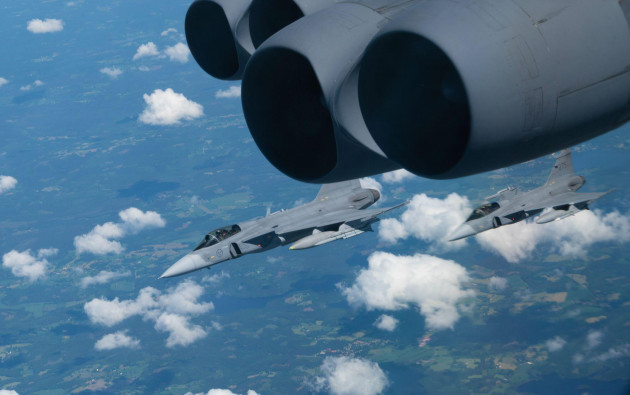 two-swedish-saab-jas-39-gripen-fighter-jets-escort-a-b-52h-stratofortress-over-europe-during-a-bomber-task-force-europe-21-3-flight-en-route-to-a-maritime-training-scenario-june-09-2021-bomber-miss