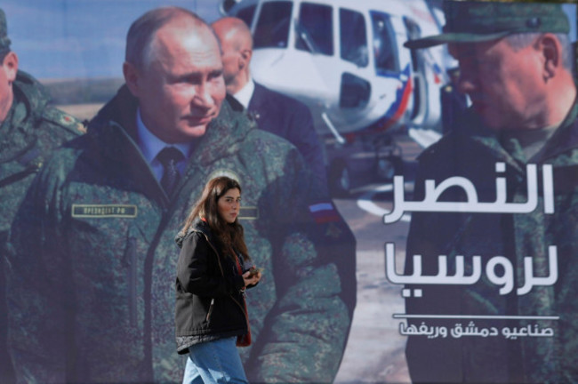 file-a-woman-passes-a-billboard-showing-russian-president-vladimir-putin-in-damascus-syria-on-march-7-2022-the-arabic-in-poster-reads-the-victory-for-russia-ap-photoomar-sanadiki-file