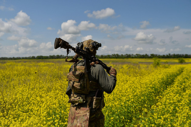vuhledar-donetsk-oblast-ukraine-25th-may-2023-a-ukrainian-soldier-from-the-68th-jager-brigade-walks-through-the-flower-fields-outside-the-city-of-vuhledar-credit-image-madeleine-kellyz