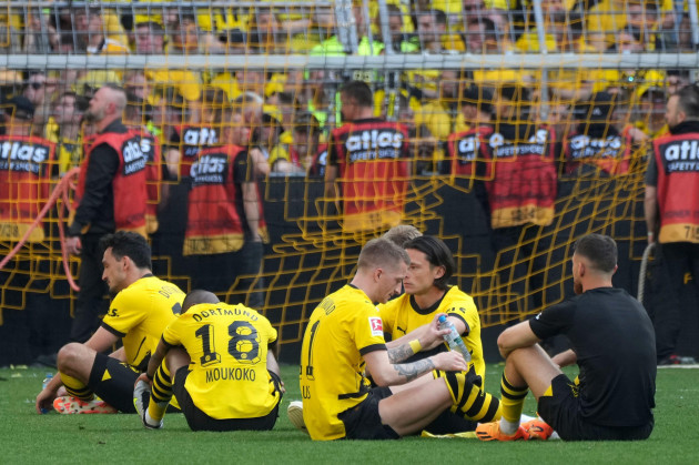 dortmunds-players-sit-on-the-pitch-after-the-german-bundesliga-soccer-match-between-borussia-dortmund-and-fsv-mainz-05-in-dortmund-germany-saturday-may-27-2023-ap-photomichael-probst