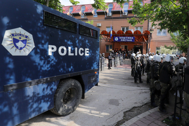 polish-soldiers-part-of-the-peacekeeping-mission-in-kosovo-kfor-right-and-kosovo-police-officers-guard-a-municipal-building-in-the-town-of-zvecan-northern-kosovo-monday-may-29-2023-serbia-cond