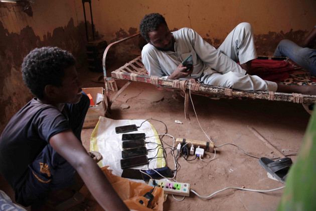 people-gather-at-the-home-of-a-volunteer-where-they-can-charge-their-mobile-phones-in-khartoum-sudan-thursday-may-25-2023-the-u-n-migration-agency-said-wednesday-that-the-fighting-between-suda