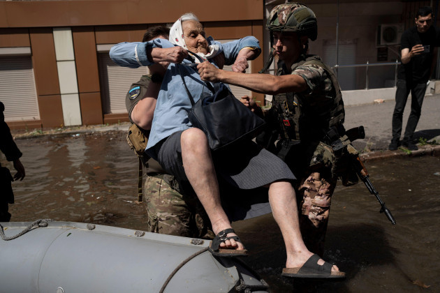 a-woman-is-evacuated-from-a-flooded-neighborhood-in-kherson-ukraine-wednesday-june-7-2023-after-the-walls-of-the-kakhovka-dam-collapsed-residents-of-southern-ukraine-braced-for-a-second-day-of-sw