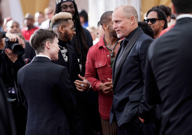 elliot-page-left-and-woody-harrelson-speak-as-they-arrive-at-the-oscars-on-sunday-march-27-2022-at-the-dolby-theatre-in-los-angeles-ap-photojae-c-hong