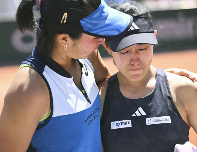 japanese-tennis-player-miyu-kato-r-appears-in-shock-as-her-indonesian-partner-aldila-sutjiadi-wraps-an-arm-around-her-shoulders-after-the-pair-were-disqualified-in-a-womens-doubles-third-round-mat