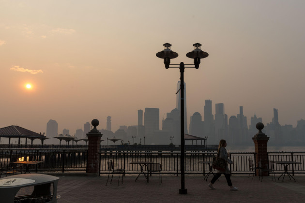 the-sun-rises-behind-the-one-world-trade-center-while-the-smoke-from-canada-wildfires-covers-the-manhattan-borough-as-it-is-seen-from-liberty-state-park-on-june-8-2023-in-new-jersey-credit-brazi