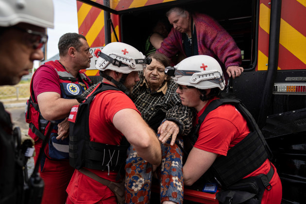 ukrainian-red-cross-volunteers-carry-an-elderly-woman-during-the-evacuation-from-a-flooded-neighborhood-in-kherson-ukraine-thursday-june-8-2023-russian-forces-on-thursday-shelled-a-southern-ukrai