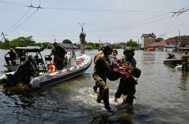 kherson-ukraine-08th-june-2023-ukrainian-military-help-an-elderly-woman-to-leave-the-boat-during-an-evacuation-from-a-flooded-area-of-kherson-on-june-6-the-russian-army-blew-up-the-dam-of-the-ka