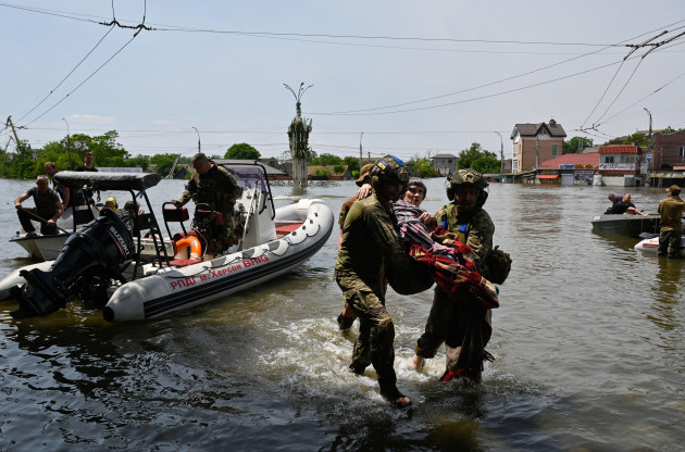 kherson-ukraine-08th-june-2023-ukrainian-military-help-an-elderly-woman-to-leave-the-boat-during-an-evacuation-from-a-flooded-area-of-kherson-on-june-6-the-russian-army-blew-up-the-dam-of-the-ka