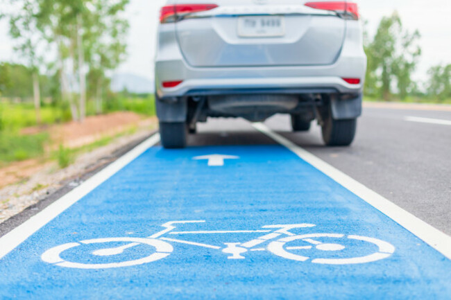 modernsuvcarrunningonasphaltroadbicyclelane