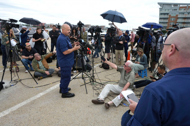 u-s-coast-guard-capt-jamie-frederick-center-left-faces-reporters-as-coast-guard-chief-public-affairs-specialist-robert-simpson-right-looks-on-during-a-news-conference-tuesday-june-20-2023-at