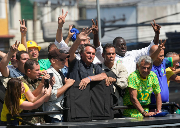 brazils-president-jair-bolsonaro-waves-to-supporters-as-he-rides-atop-a-cargo-truck-during-a-campaign-rally-in-sao-joao-de-meriti-rio-de-janeiro-state-brazil-thursday-oct-27-2022-bolsonaro-is