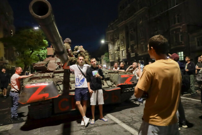 servicemen-of-the-wagner-group-military-company-sit-atop-of-a-tank-as-local-civilians-pose-for-a-photo-prior-to-their-leave-an-area-at-the-hq-of-the-southern-military-district-in-a-street-in-rostov-o