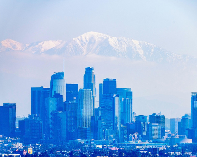 march-3-2023-los-angeles-ca-usa-a-view-of-downtown-la-with-the-snowy-peak-of-mount-baldy-and-the-san-gabriel-mountains-behind-it-in-los-angeles