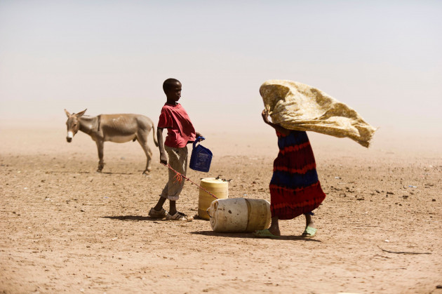 a-boy-and-a-woman-struggle-with-the-dusty-wind-looking-for-water-july-16-2011-in-wajir-kenya