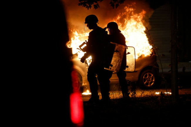 riot-police-stand-near-a-burning-car-in-the-la-meinau-neighborhood-of-strasbourg-eastern-france-on-friday-june-30-2023-young-rioters-clashed-with-police-and-looted-stores-friday-in-a-fourth-day-o