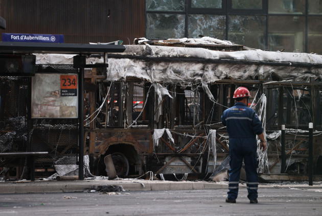 aubervilliers-france-1st-july-2023-a-staff-member-works-near-burnt-buses-at-the-fort-daubervilliers-bus-terminal-in-aubervilliers-north-of-paris-france-june-30-2023-violence-continued-in-fr