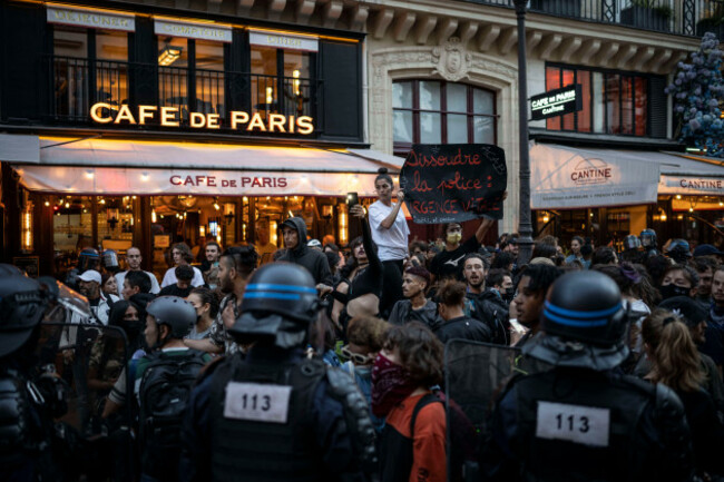 a-protester-holds-a-placard-reading-dismiss-the-police-is-urgent-during-a-demonstration-in-paris-on-june-30-2023-over-the-shooting-of-a-teenage-driver-by-french-police-in-a-paris-suburb-on-june-27