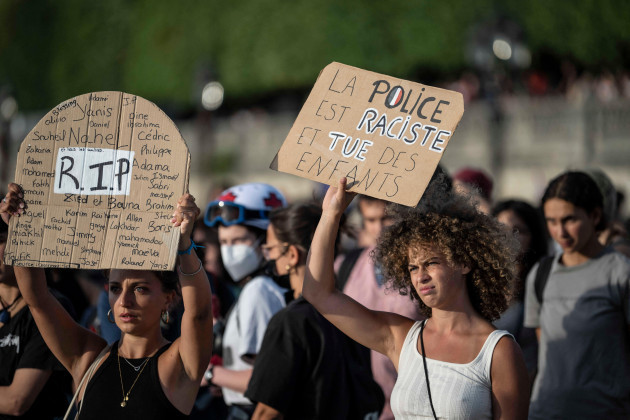 paris-france-30th-june-2023-a-woman-holds-a-placard-reading-police-are-racist-and-kill-children-during-a-protest-in-paris-france-friday-june-30-2023-frances-interior-minister-says-theres