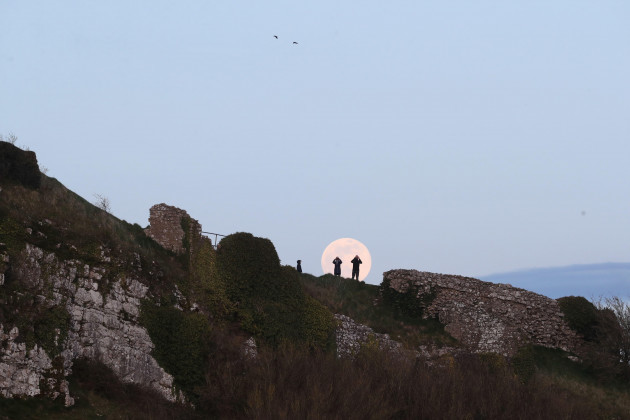 a-pink-supermoon-rises-over-the-rock-of-dunamase-in-county-laois-in-the-republic-of-ireland-despite-its-name-there-is-no-actual-colour-change-to-the-appearance-of-the-lunar-surface-it-is-a-norther