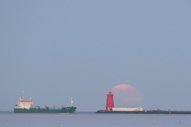 the-final-supermoon-of-the-year-rises-over-poolbeg-lighthouse-in-dublin-bay-ireland-the-full-moon-in-may-is-also-known-as-the-flower-moon-signifying-the-flowers-that-bloom-during-the-month