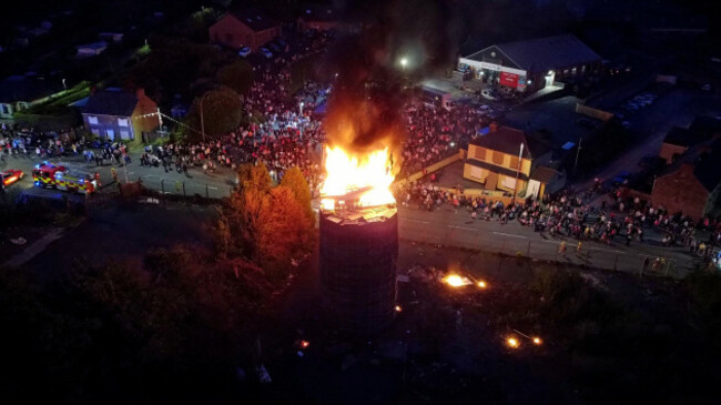 people-watch-as-the-pyre-with-a-boat-on-top-with-a-picture-of-taoiseach-leo-varadkar-and-a-banner-that-reads-good-friday-agreement-that-ship-has-sailed-is-set-alight-in-moygashel-near-dungannon