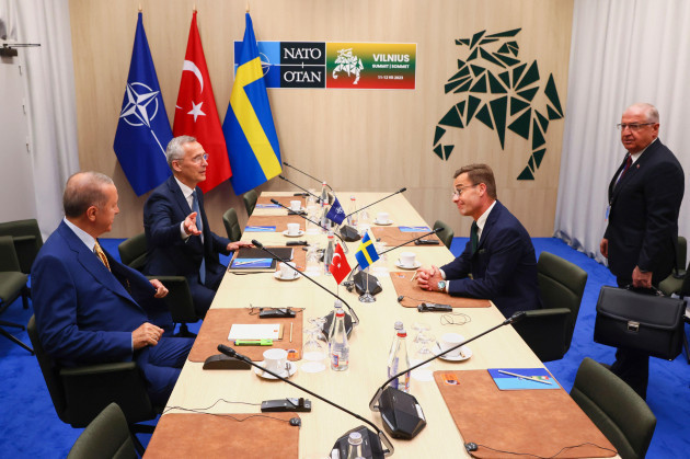 nato-secretary-general-jens-stoltenberg-second-left-speaks-with-turkeys-president-recep-tayyip-erdogan-left-swedens-prime-minister-ulf-kristersson-second-right-and-turkeys-defense-minister-ya