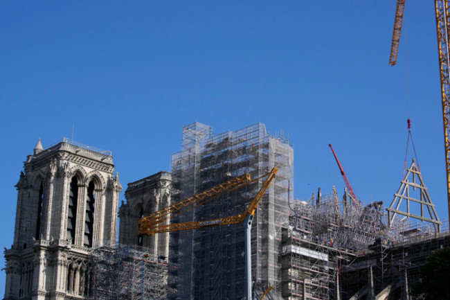 a-crane-lifts-a-huge-oak-frame-at-notre-dame-de-paris-cathedral-tuesday-july-11-2023-in-paris-the-panels-are-due-to-be-reassembled-on-the-top-of-notre-dame-to-replace-the-roof-that-flames-turned-i