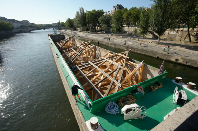 a-barge-loaded-with-huge-oak-frames-arrives-near-notre-dame-de-paris-cathedral-tuesday-july-11-2023-in-paris-the-panels-are-due-to-be-reassembled-on-the-top-of-notre-dame-to-replace-the-roof-that