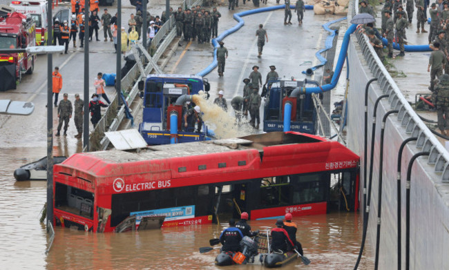 rescuers-search-for-survivors-along-a-road-submerged-by-floodwaters-leading-to-an-underground-tunnel-in-cheongju-south-korea-sunday-july-16-2023-days-of-heavy-rain-triggered-flash-floods-and-land