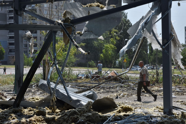 zaporizhzhia-ukraine-15th-july-2023-a-man-is-walking-by-a-car-service-heavily-damaged-by-russian-shelling-in-zaporizhzhia-the-russian-armed-forces-attacked-the-outskirts-of-zaporizhzhia-twice-usi